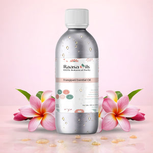 Raasa Oils frangipani essential oil bottle with flowers on a pink background