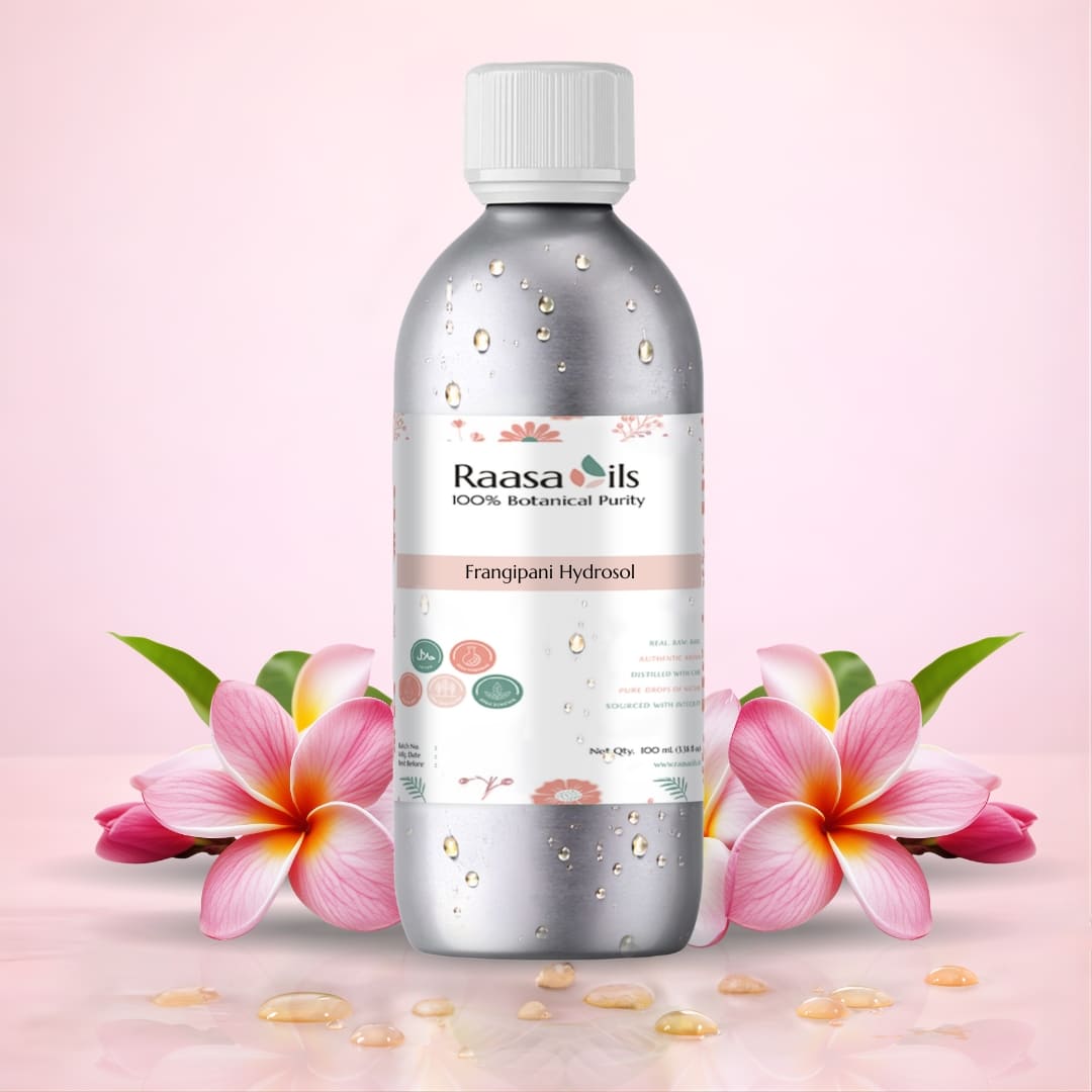 Bottle of Raasa Oils Frangipani Hydrosol with a flower and leaf on a light pink background
