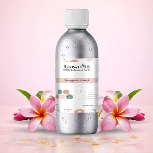 Bottle of Raasa Oils Frangipani Hydrosol with a flower and leaf on a light pink background