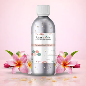 Raasa Oils bottle with frangipani flowers on a pink background