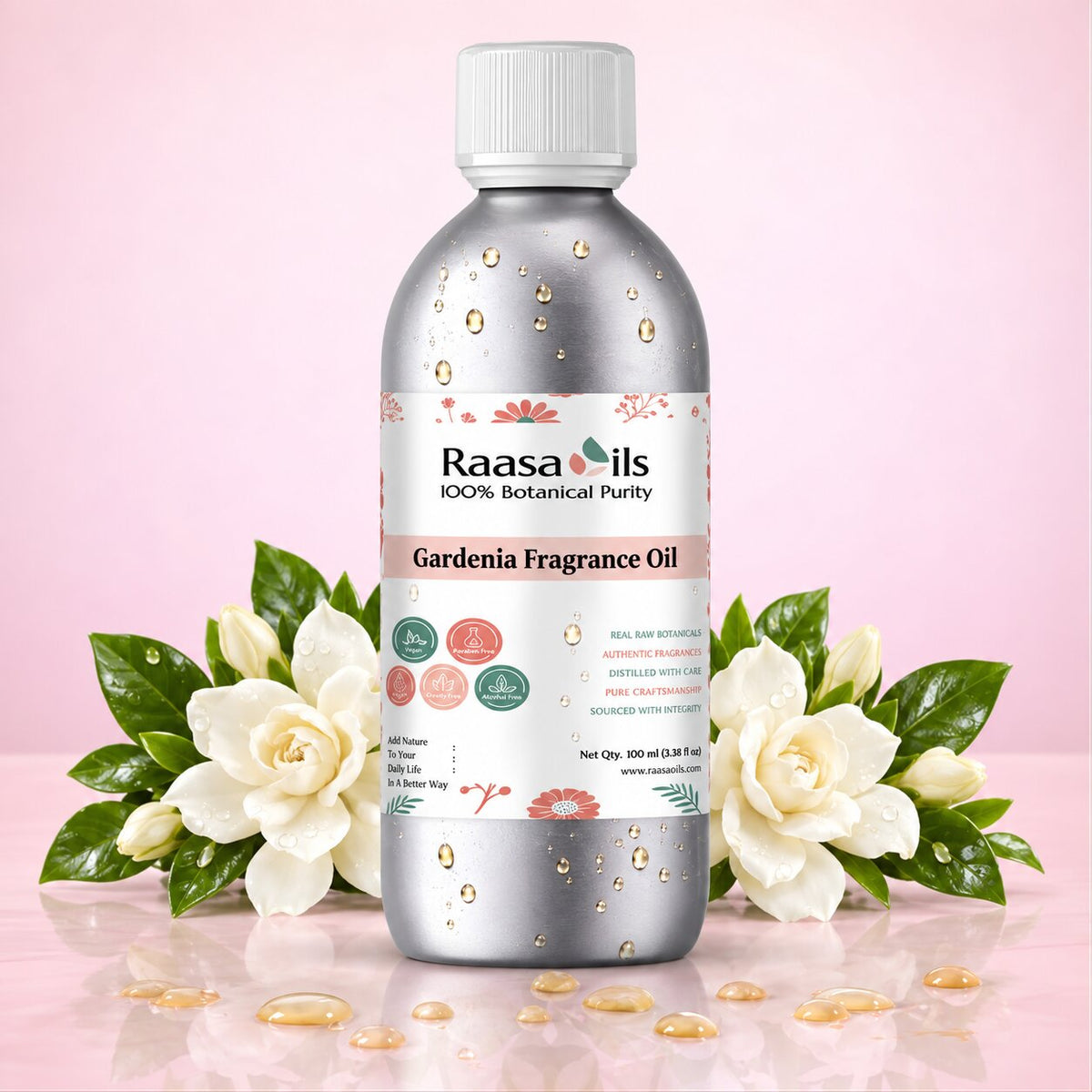 A bottle of Raasa oils Gardenia Fragrance Oil centered on a pink background, flanked by white gardenia flowers and green leaves. The bottle is metallic silver with a white cap and a detailed white label featuring botanical illustrations.