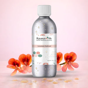 Bottle of Raasa Oils Geranium Hydrosol with flowers on a pink background