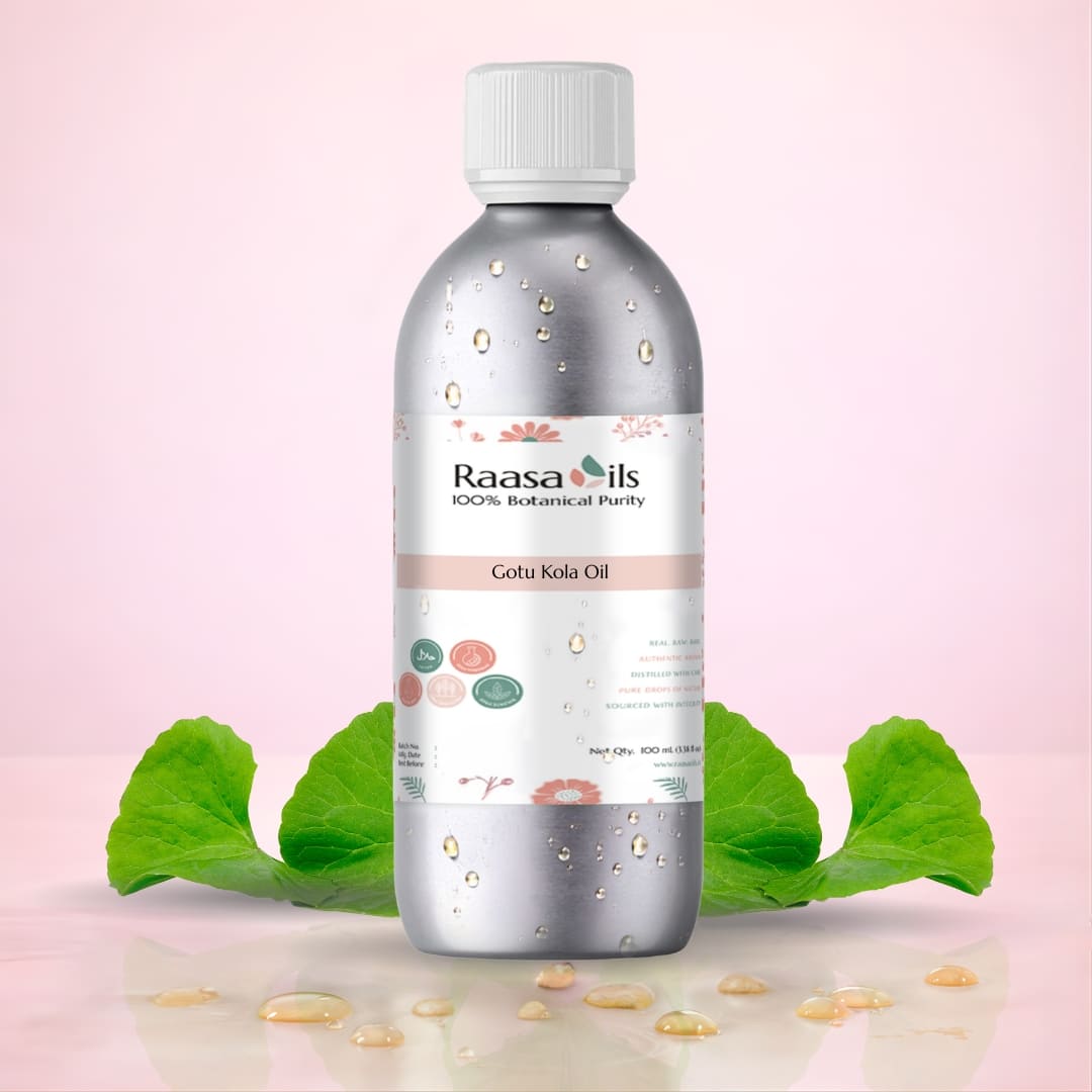 Bottle of Raasa Oils Gota Kola Oil with green leaves on a pink background