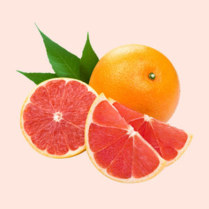 A whole grapefruit with a leaf attached and a sliced grapefruit showing the red interior, isolated on a white background.