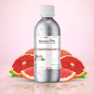 Grapefruit fragrance oil bottle with slices of grapefruit on a pink background