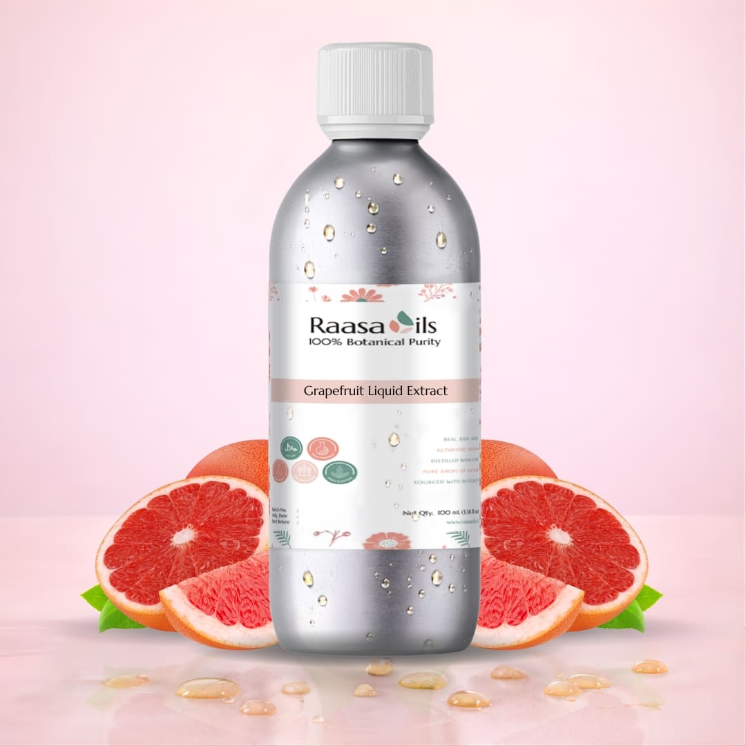 Bottle of Raasa Oils Grapefruit Liquid Extract with grapefruit slices on a pink background
