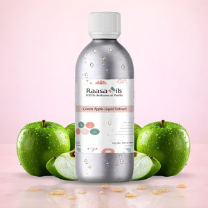 Bottle of Raasa Oils Green Apple Liquid Extract with green apples on a pink background