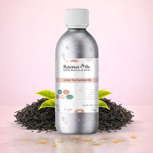 Raasa Oils Green Tea Essential Oil bottle with tea leaves on a pink background