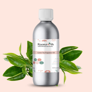 Bottle of Raasa Oils Green Tea Fragrance Oil with green leaves on a beige background