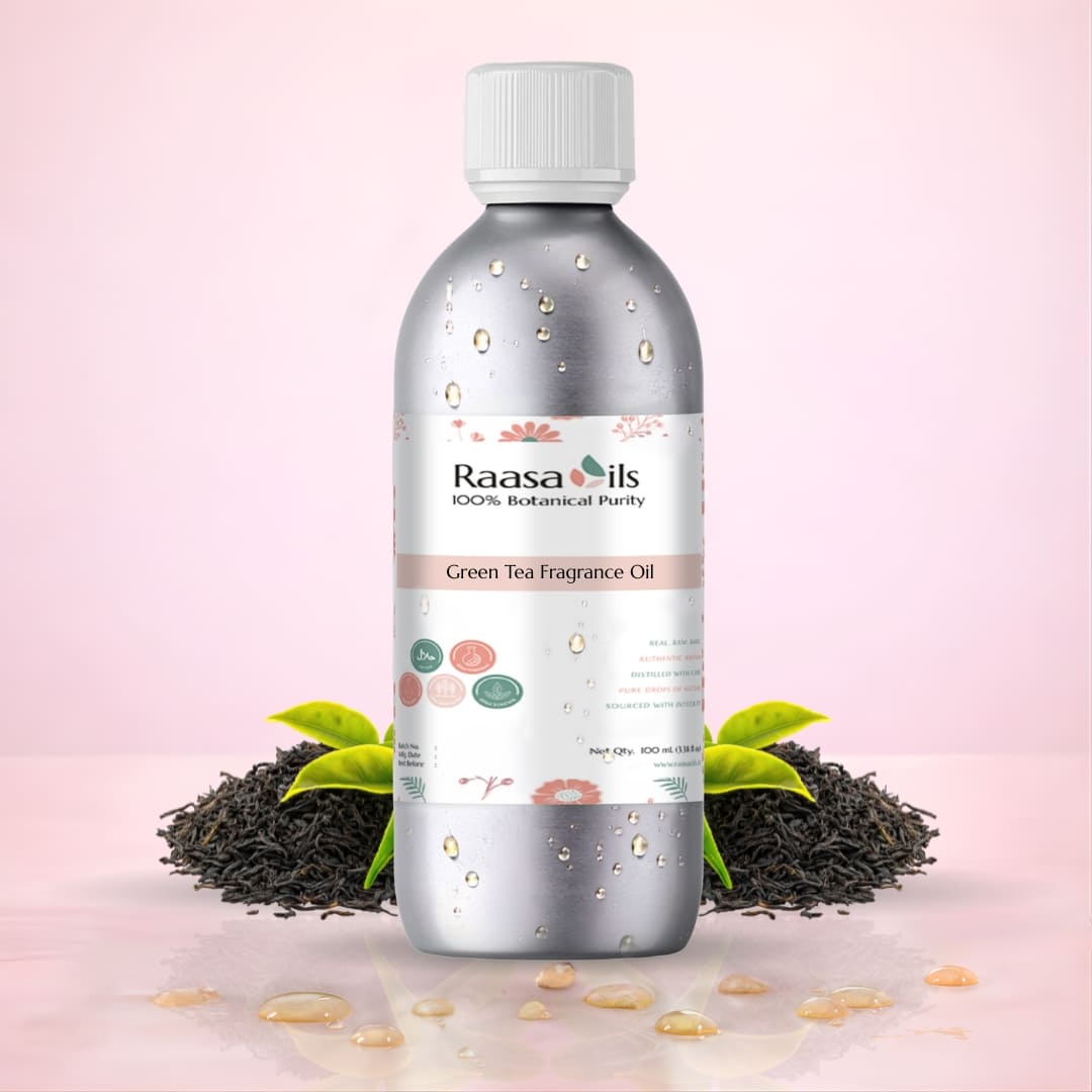 Bottle of Raasa Oils Green Tea Fragrance Oil with green tea leaves on a pink background