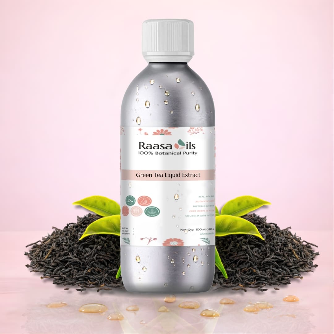 Bottle of Raasa Oils Green Tea Liquid Extract with tea leaves and tea leaves on a pink background