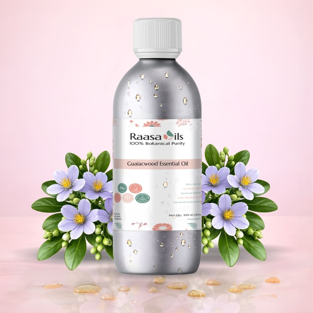 Raasa Oils Gulaalwood Essential Oil bottle with flowers on a pink background