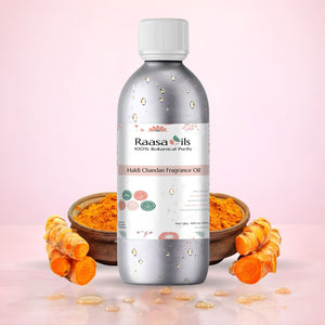 Raasa Oils Haldi Chandan Fragrance Oil bottle with turmeric roots on a pink background