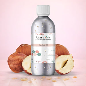 Bottle of Raasa Oils Hazelnut Oil with hazelnuts on a pink background