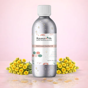 Bottle of Raasa Oils Helichrysum Essential Oil with yellow flowers on a pink background