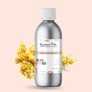 Bottle of Raasa Oils Helichrysum Hydrosol with flowers on a light pink background