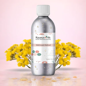 Bottle of Raasa Oils Helichrysum Hydrosol with yellow flowers on a pink background