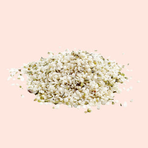 Small pile of white seeds on a light pink background