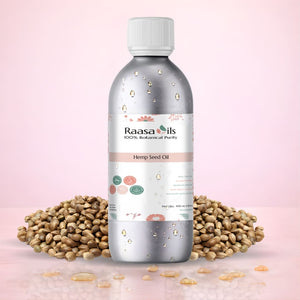 Bottle of Raasa Oils Hemp Seed Oil with hemp seeds on a pink background