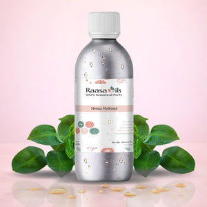 Raasa Oils bottle with green leaves on a pink background