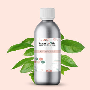 Bottle of Raasa Oils Henna Liquid Extract with green leaves on a light pink background