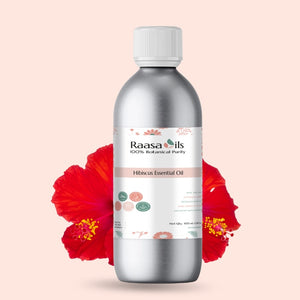 Bottle of Raasa Oils Hibiscus Essential Oil with a red flower on a beige background