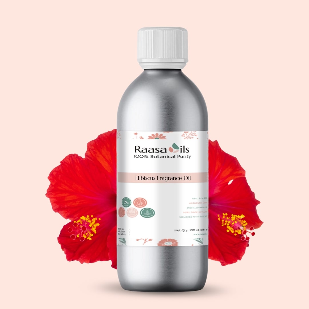 Bottle of Raasa Oils Hibiscus Fragrance Oil with a red flower on a beige background