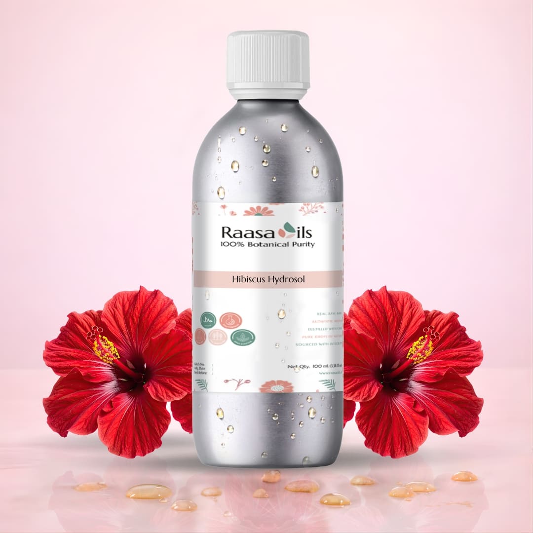 Bottle of Raasa Oils Hibiucus Hydrosol with a red flower on a beige background