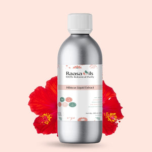 Bottle of Raasa Oils Hibiscus Liquid Extract with red flowers on a light pink background