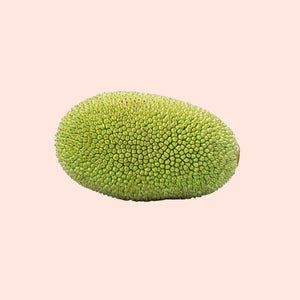 Green jackfruit on a beige background