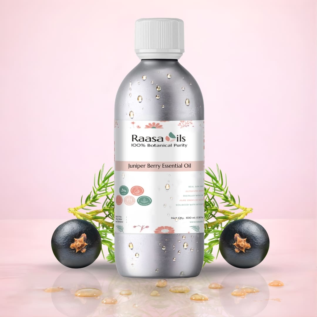 Raasa Oils Juniper Berry Essential Oil bottle with juniper berries on a pink background