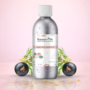 Raasa Oils Juniper Berry Essential Oil bottle with juniper berries on a pink background