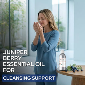 Woman using Juniper Berry essential oil with product and berries on a table.