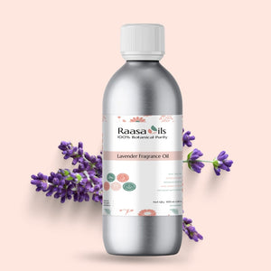 Bottle of Raasa Oils lavender fragrance oil with lavender flowers on a light pink background