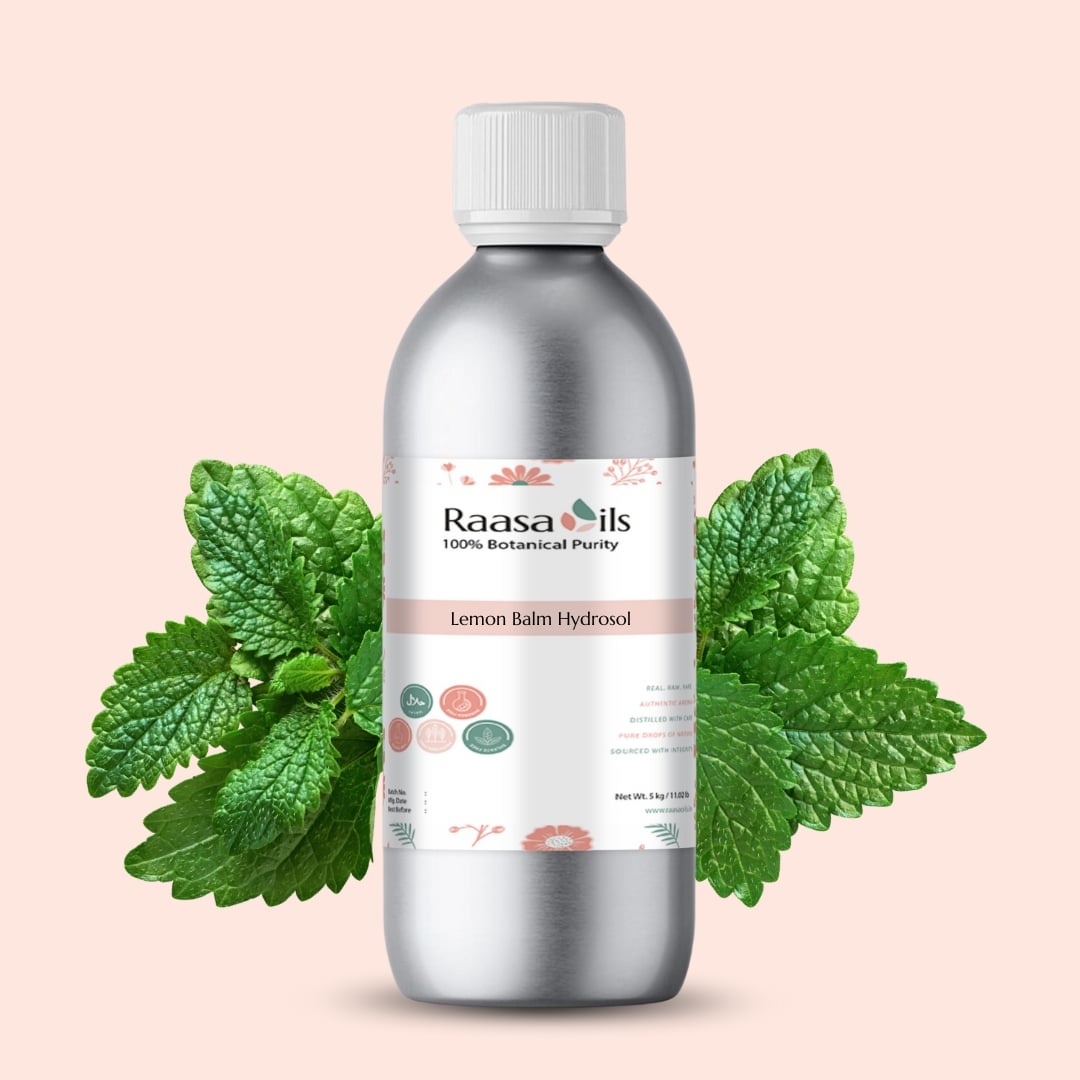 Silver bottle of Raasa Oils Lemon Balm Hydrosol with green leaves on a light pink background