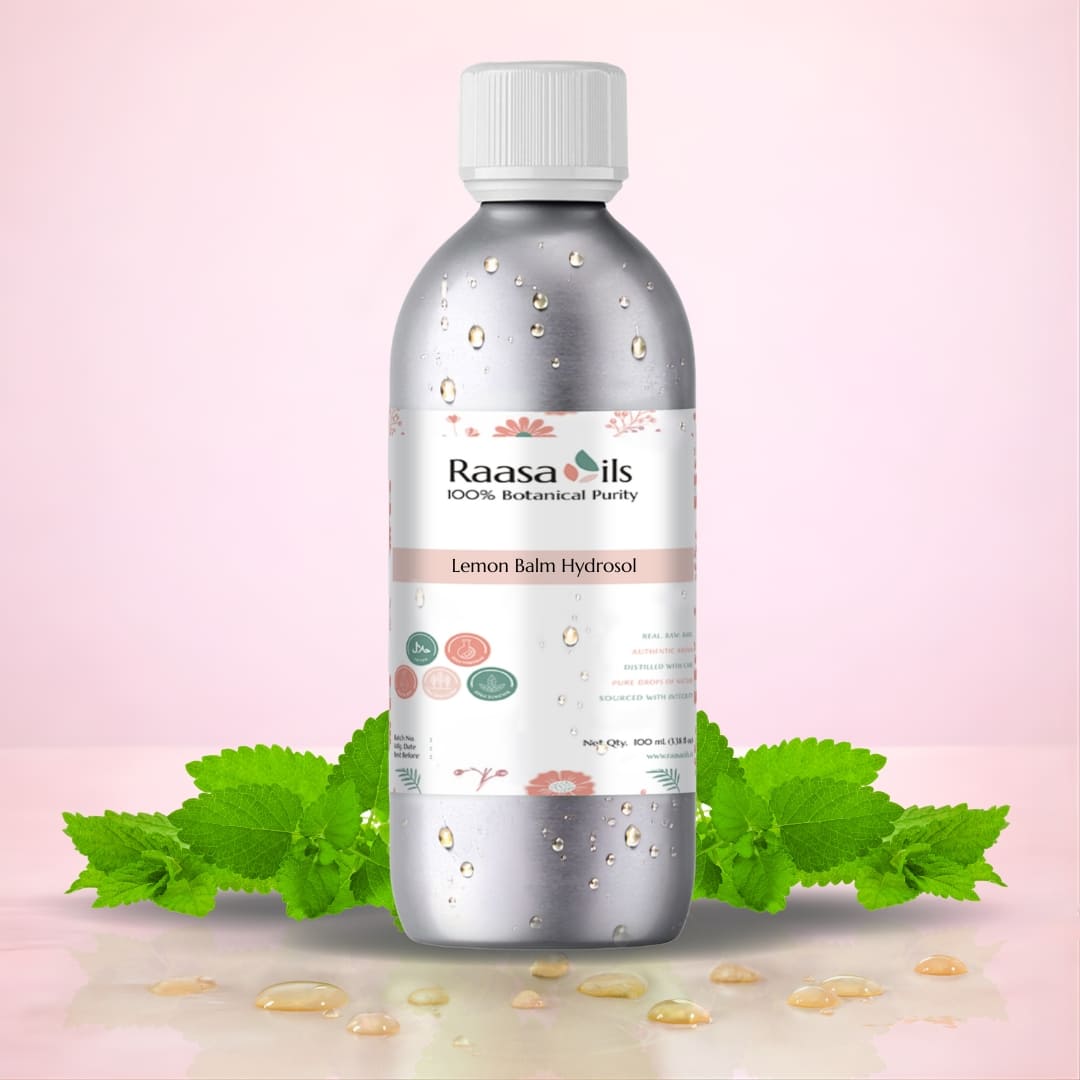 Bottle of Raasa Oils Lemon Balm Hydrosol with green leaves on a pink background