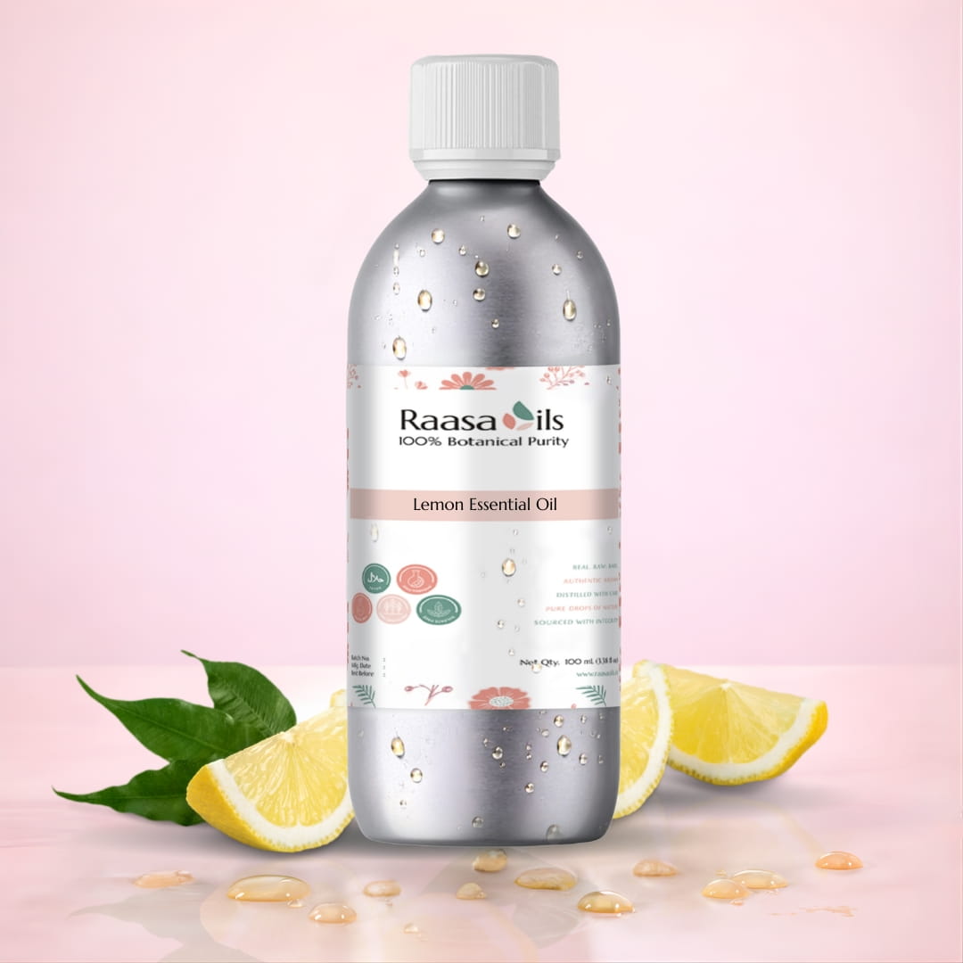 Bottle of Raasa Oils Lemon Essential Oil with lemon slices and leaves on a pink background