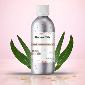 Raasa Oils Lemon Eucalyptus Essential Oil bottle with leaves on a pink background