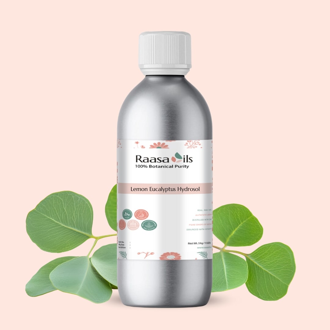 Bottle of Raasa Oils Lemon Eucalyptus Hydrosol with eucalyptus leaves on a light pink background