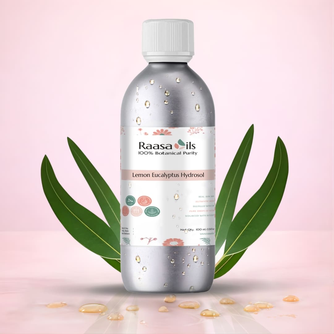 Bottle of Raasa Oils Lemon Eucalyptus Hydrosol with eucalyptus leaves on a pink background