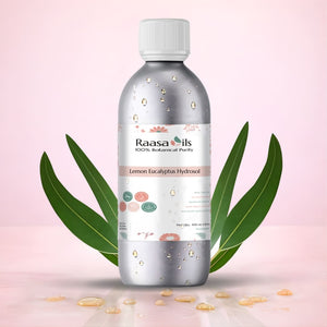 Bottle of Raasa Oils Lemon Eucalyptus Hydrosol with eucalyptus leaves on a pink background