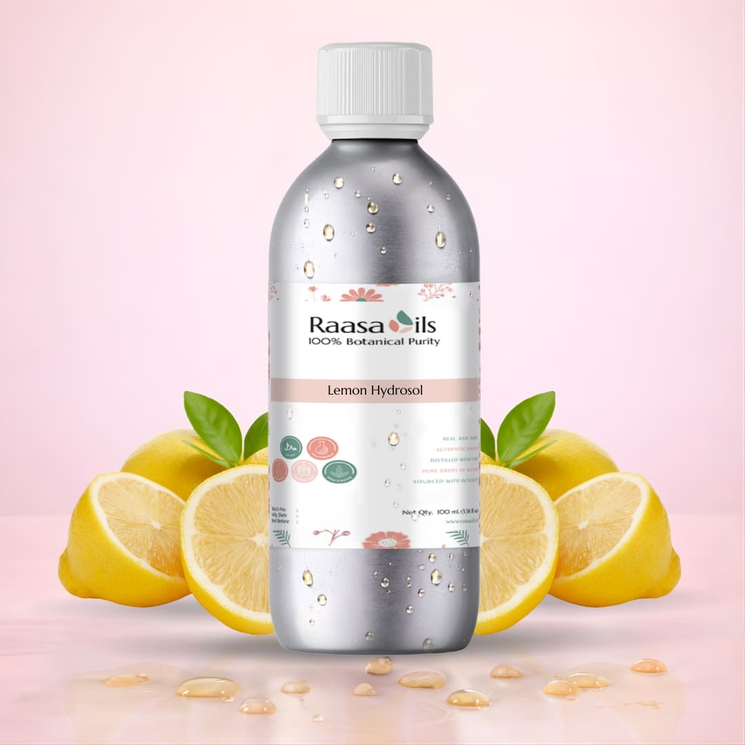 Bottle of Raasa Oils Lemon Hydrosol with lemons on a pink background