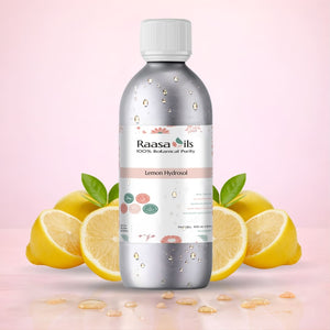 Bottle of Raasa Oils Lemon Hydrosol with lemons on a pink background