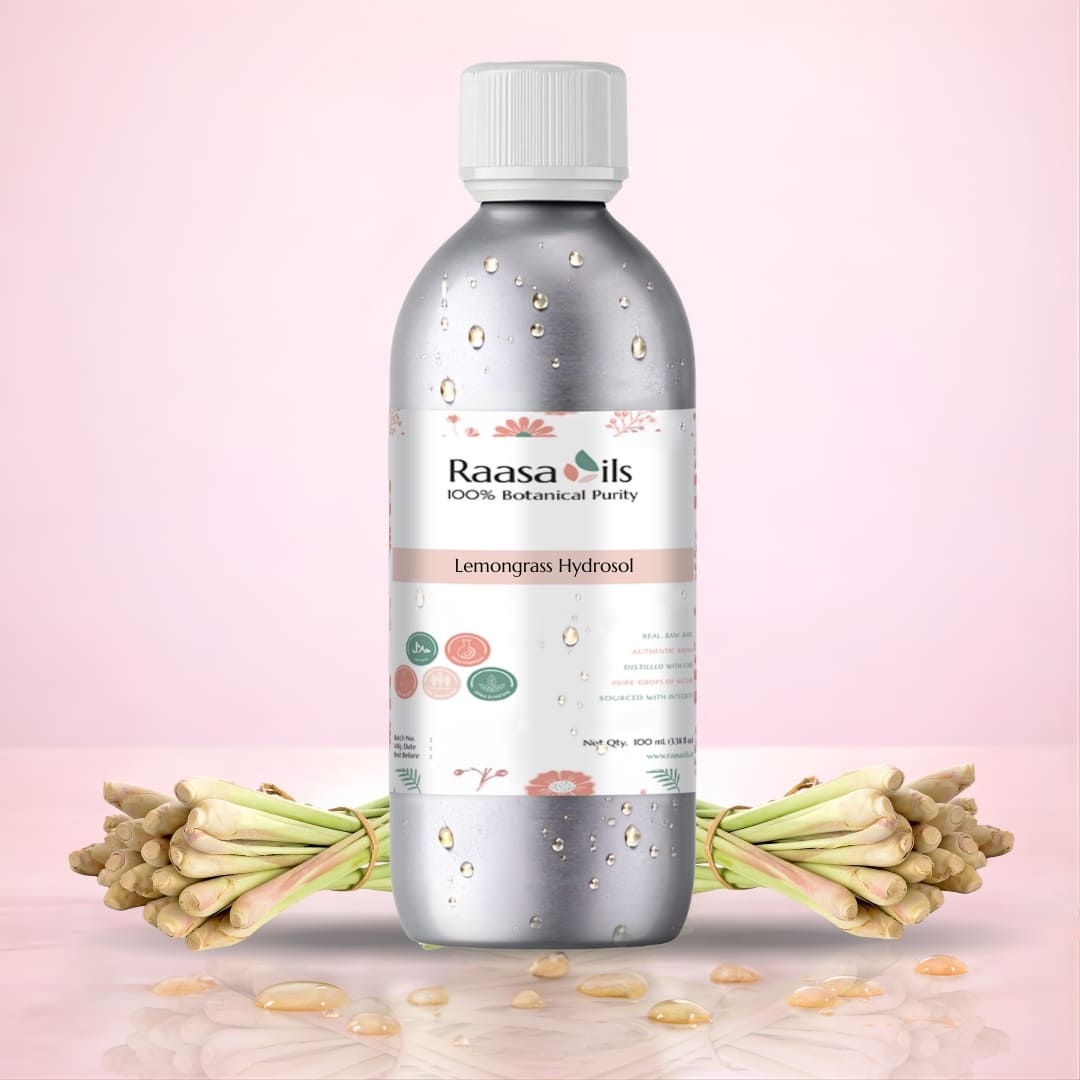 Bottle of Raasa Oils Lemongrass Hydrosol with lemongrass stalks on a pink background