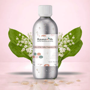 Raasa Oils fragrance oil bottle with lily of the valley flowers on a pink background