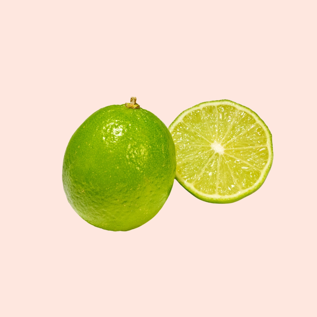 An image of a whole lime and a slice of lime on a white background.