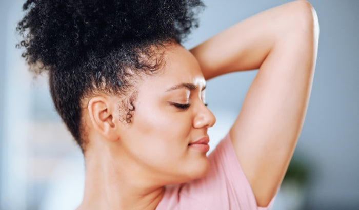 Woman with a small mole on her arm against a blurred background
