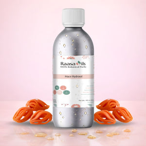 Bottle of Raasa Oils Mace Hydrofol with mace seeds on a pink background