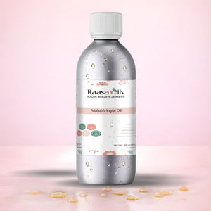 Bottle of Raasa Oils Mahabhringraj Oil on a pink background