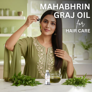 Woman applying oil to her hair with Mahabhrin Graj Oil packaging in the foreground